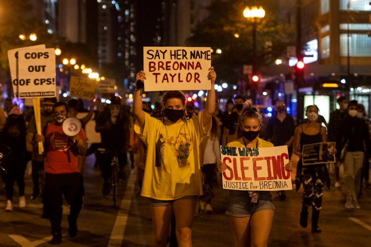 People march on State Street in Chicago's Loop neighborhood, during protests in Chicago demanding justice for Breonna Taylor, on Sept. 23, 2020. (Tyler LaRiviere/Chicago Sun-Times via AP)