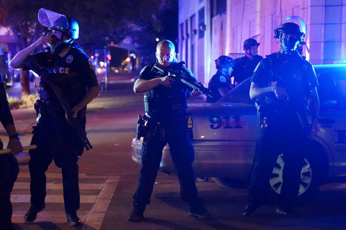Police stand at an intersection after an officer was shot, in Louisville, Ky., on Sept. 23, 2020. (John Minchillo/AP Photo)