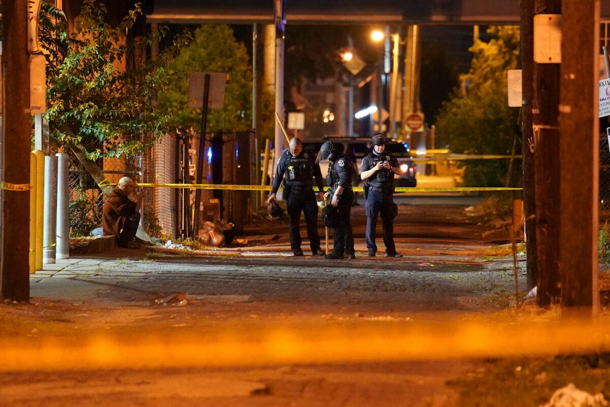 Police survey an area after a police officer was shot in Louisville, Ky., during rioting on Sept. 23, 2020. (John Minchillo/AP Photo)