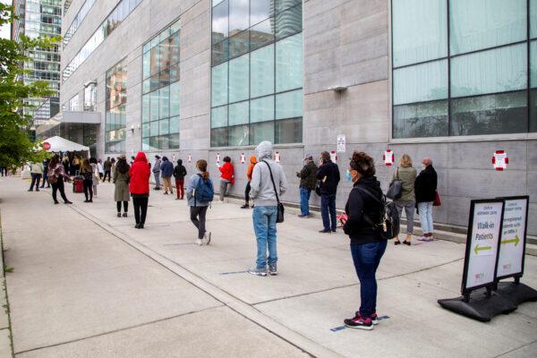 People wait in line at the Women's College COVID-19 testing facility in Toronto on Sept. 18, 2020. (Reuters/Carlos Osorio)