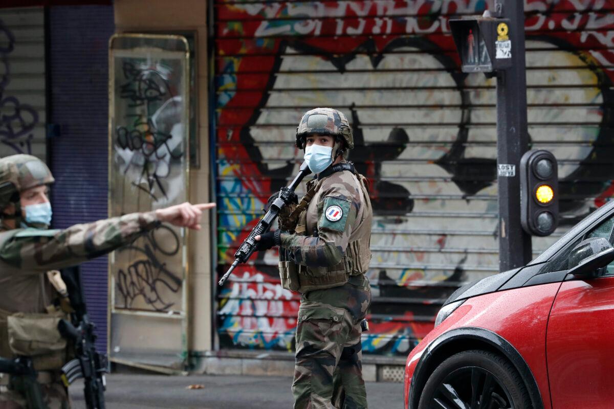 French soldiers patrol after two people have been wounded in a knife attack near the former offices of satirical newspaper Charlie Hebdo, Paris, on Sept. 25, 2020. (Thibault Camus/AP Photo)