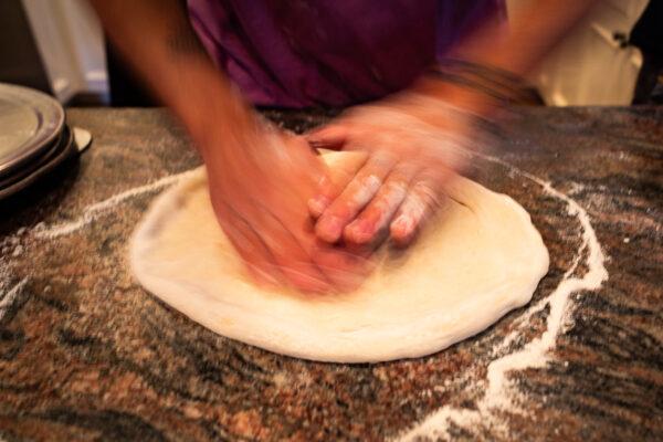 Landon Pietrini prepares pizza dough at his parents' house in Seal Beach, Calif., on Sept. 19, 2020. (John Fredricks/The Epoch Times)