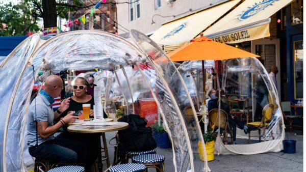People sit outside Cafe du Soleil under bubble tents in New York City, on Sept. 23, 2020. (Jeenah Moon/Reuters)