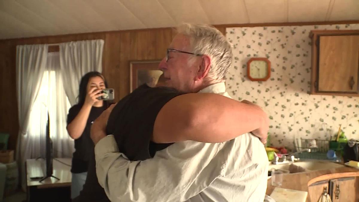 Derlin Newey, a pizza delivery driver in Utah, hugs the Valdez family after being surprised with a tip of a lifetime. (KSL TV)