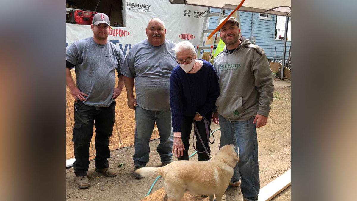 Gloria surrounded by members of the "Gloria's Gladiators" team who helped rebuild her home. (Courtesy of John Kinney/Gloria's Gladiators)