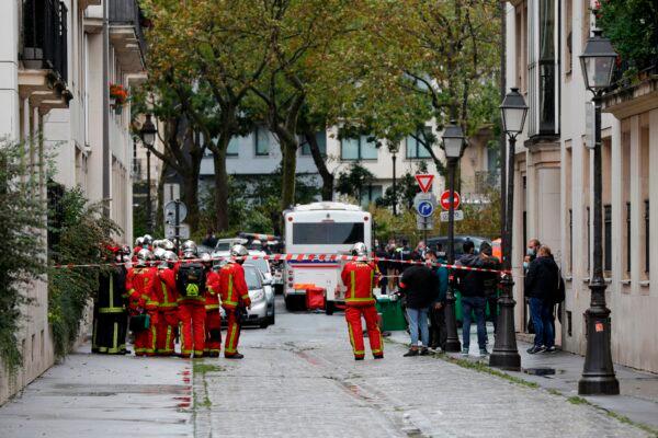 French firefighters gather at the scene of an attack in which several people were injured near the former offices of the French satirical magazine Charlie Hebdo by a man wielding a knife in the capital Paris on Sept. 25, 2020. (Geoffrey Van Der Hasselt/AFP via Getty Images)