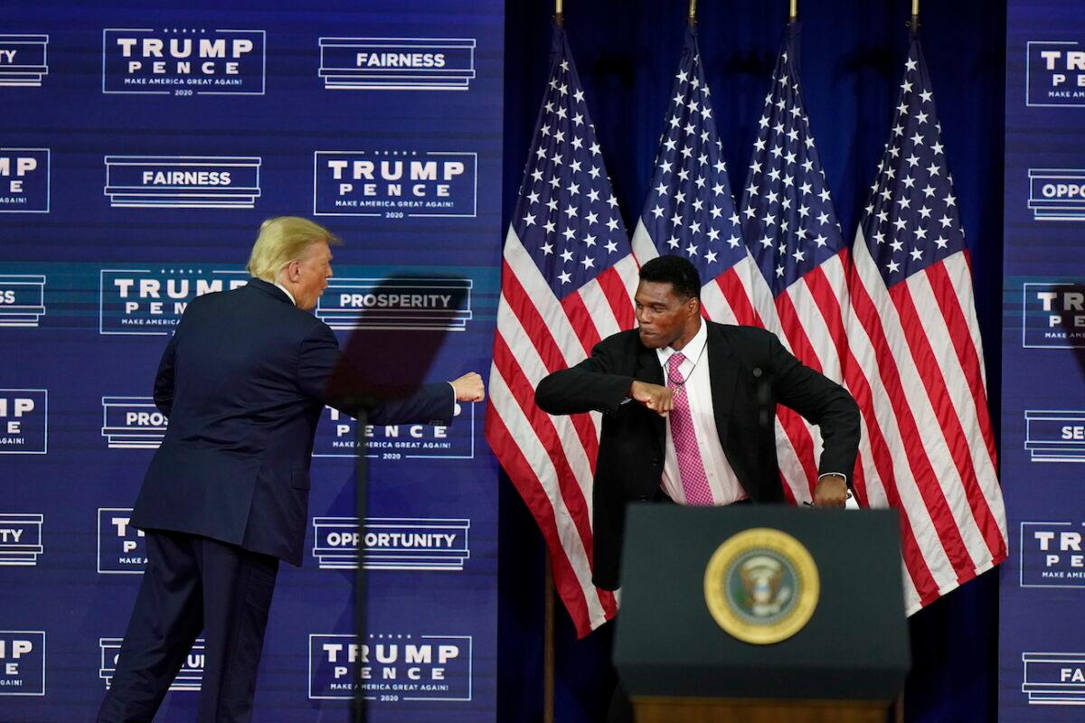 President Donald Trump elbow bumps with Herschel Walker during a campaign rally in Atlanta on Sept. 25, 2020. (AP Photo/John Bazemore)