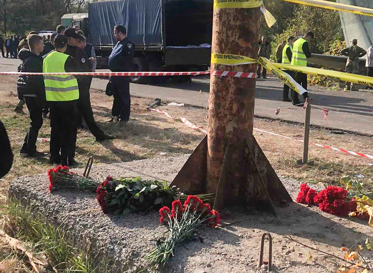 Flowers lay at the scene where the AN-26 military plane crashed on Friday night, in the town of Chuguyiv close to Kharkiv, Ukraine, on Sept. 26, 2020. (Emergency Situation Ministry via AP Photo)