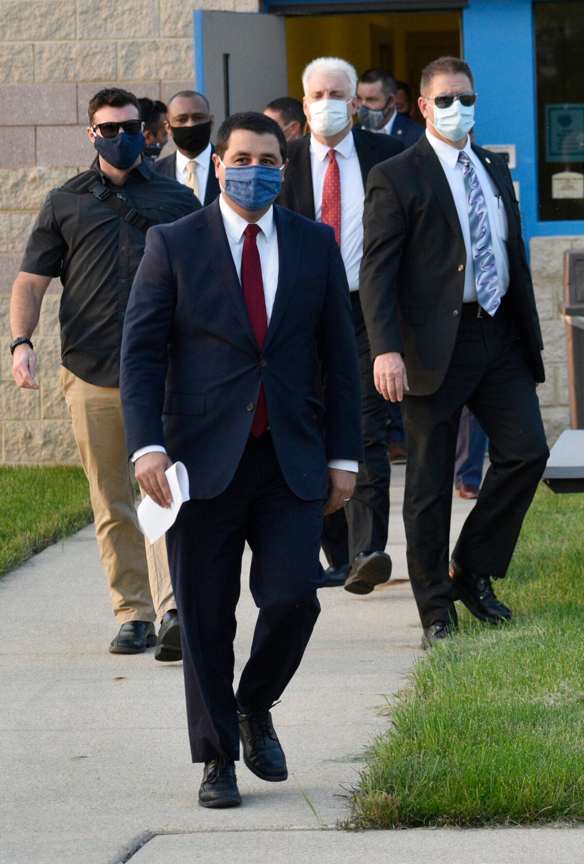 Wisconsin Attorney General Josh Kaul heads to the podium for a news conference. Noble Wray, former Madison police chief, is third from left while Kenosha County District Attorney Michael Gravely is second from right, in Kenosha, Wis., on Sept. 21, 2020. (Dan Truttschel/Kenosha News via AP)