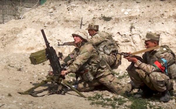 Azerbaijan's soldiers fire from a mortar at the contact line of the self-proclaimed Republic of Nagorno-Karabakh, Azerbaijan, on Sept. 27, 2020. (Azerbaijan's Defense Ministry via AP)