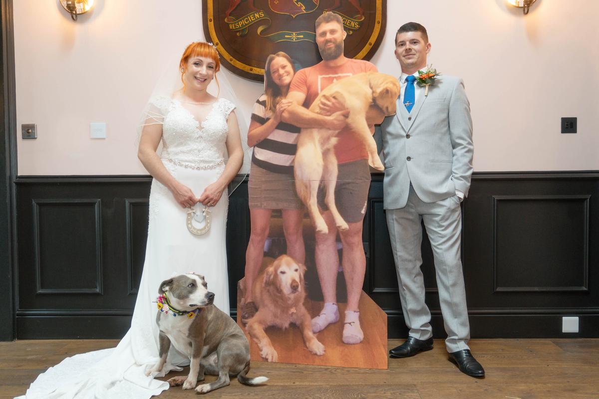 Romanee, 34, and Sam Rondeau-Smith, 30, from Bramley, Guildford​, with the cardboard cutout of their wedding guest​s. (Caters News)