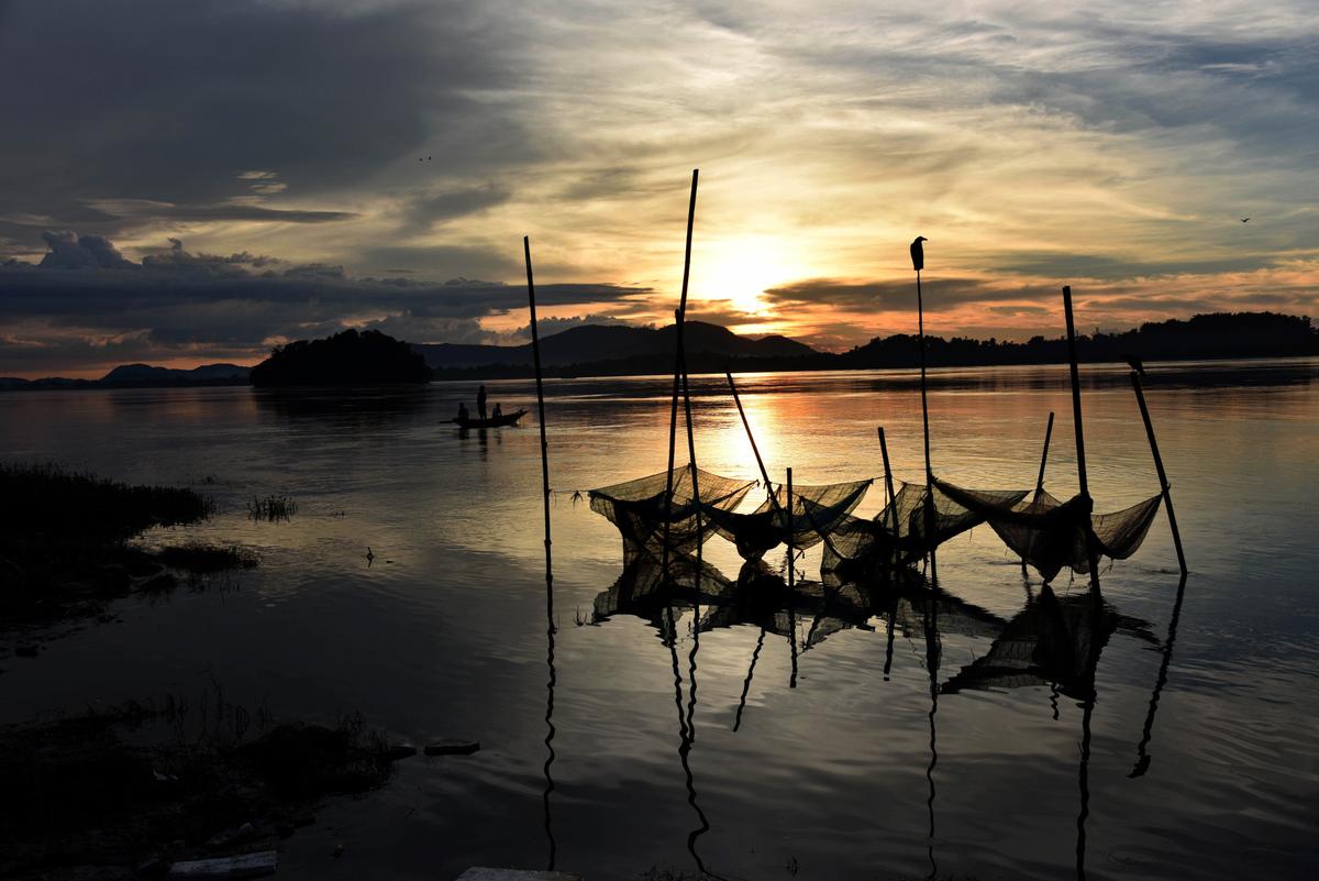 Indian fishermen paddle down the Brahmaputra River during sunset at Ujanbazar Ghat in Guwahati, India, on June 25, 2015. The Brahmaputra originates in Tibet, where it's known as the Yarlung Zangbo. (Biju Boro/AFP via Getty Images)