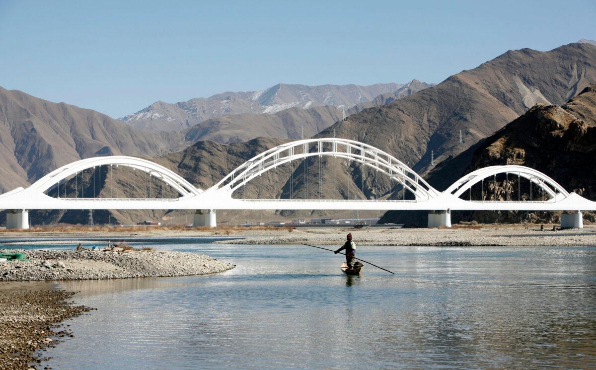 A man from Sichuan Province fishes in the Yarlung Tsangpo River, in Doilungdeqen County of Tibet on Dec. 18, 2008. (China Photos/Getty Images)
