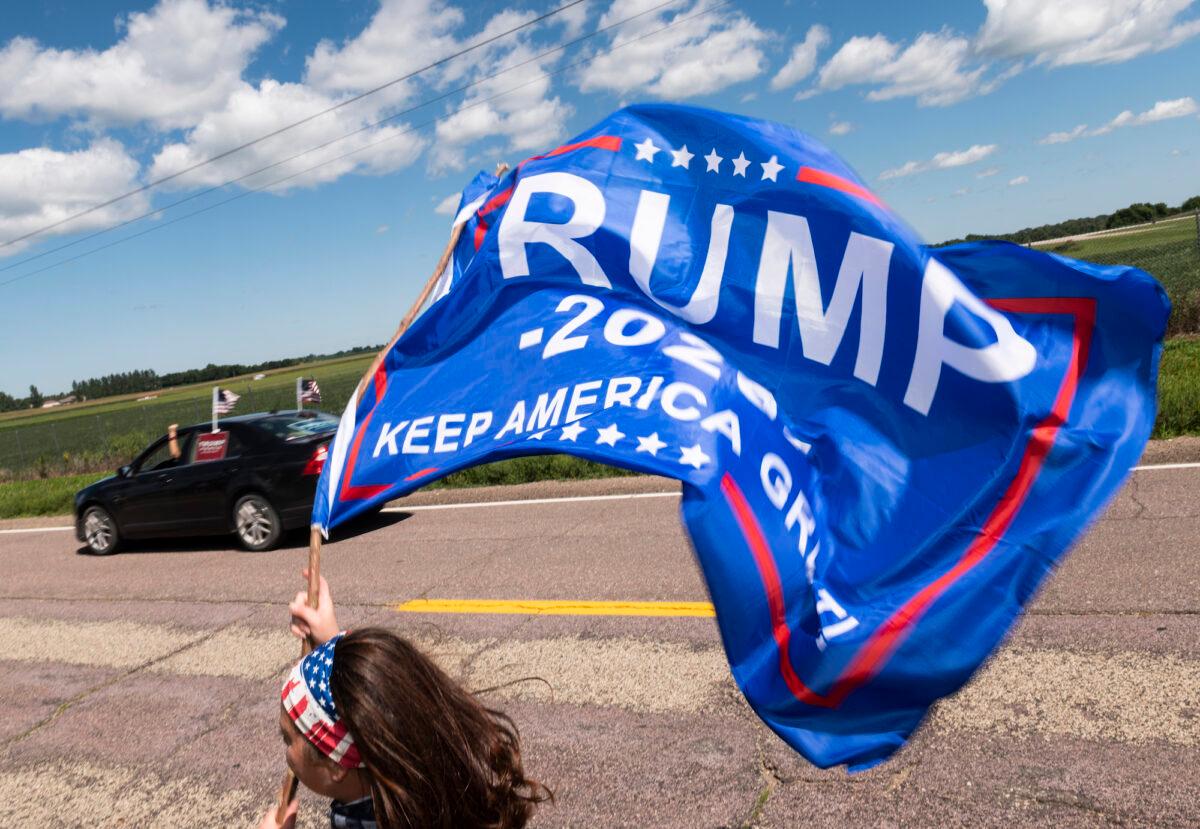 Trump supporters with flags outside of Mankato Regional Airport as President Donald Trump makes a campaign stop in Mankato, Minn., on Aug. 17, 2020. (Stephen Maturen/Getty Images)