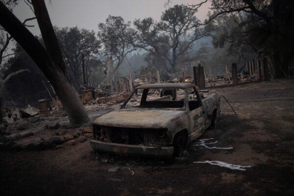 The remains of a vehicle and home are seen in the aftermath of the Glass Fire in Deer Park, Calif., on Sept. 28, 2020. (Adrees Latif/Reuters)