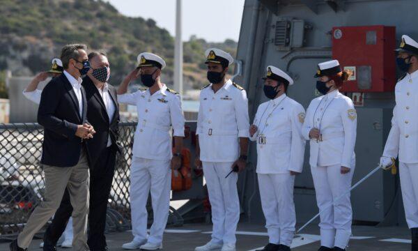 U.S. Secretary of State Mike Pompeo and Greek Prime Minister Kyriakos Mitsotakis are saluted as they walk towards the Greek frigate Salamis during their visit to the Naval Support Activity base at Souda, Crete, Greece, on Sept. 29, 2020. (Aris Messinis/Pool via Reuters)