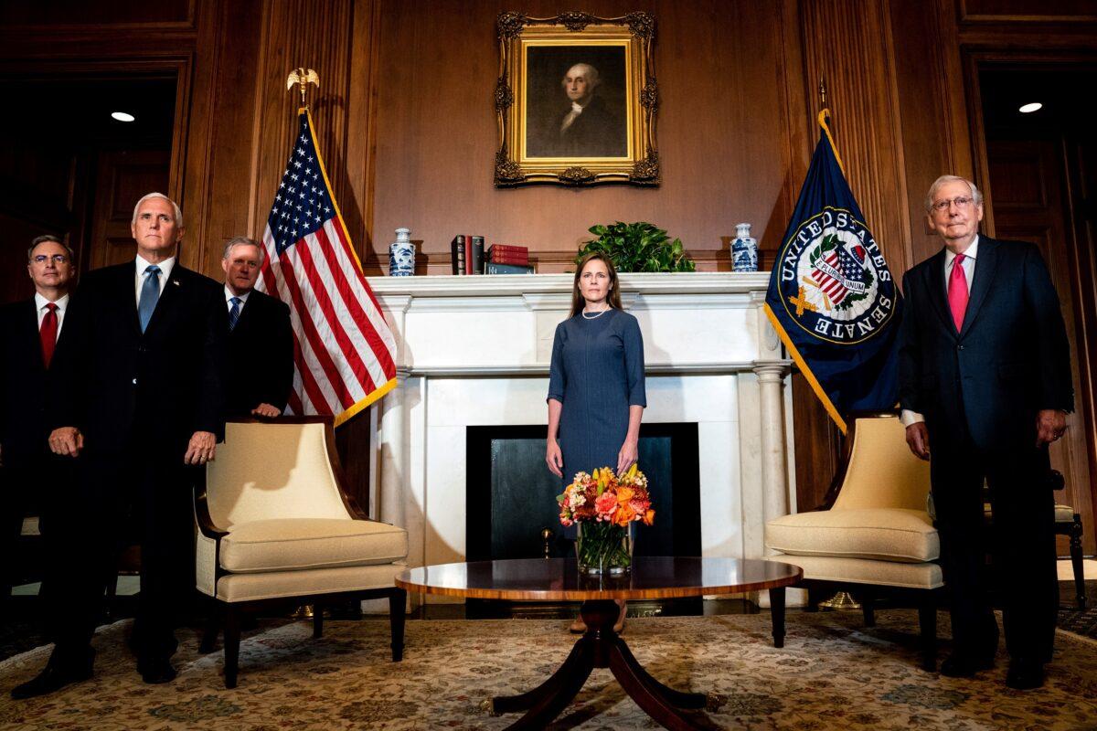 Supreme Court nominee Judge Amy Coney Barrett, center, meets with Senate Majority Leader Mitch McConnell (R-Ky.), right, and Vice President Mike Pence, front left, on Capitol Hill in Washington on Sept. 29, 2020. (Erin Schaff/Pool via Reuters)
