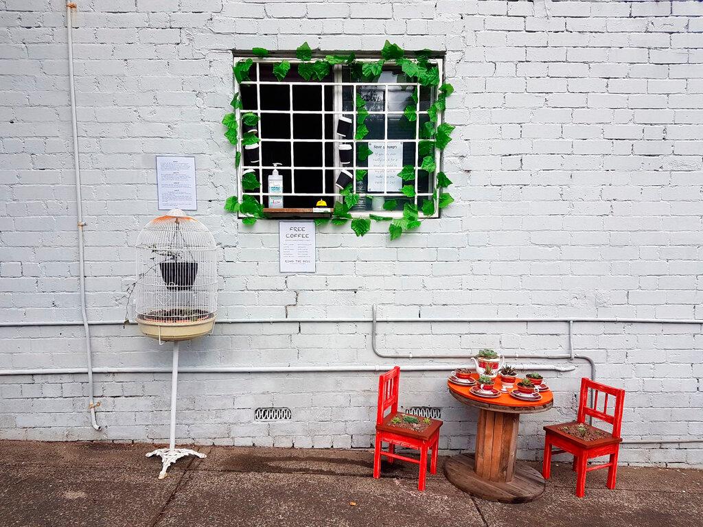 A small table decorated with succulents sits below a window where Everett offers free coffee and conversation to friends and neighbors at his home in Sydney, Australia, during the coronavirus pandemic. (Rick Everett via AP)