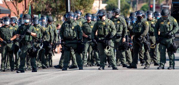 Orange County Sheriff deputies line up as Black Lives Matter protesters and counter-protesters clash in Yorba Linda, Calif., on Sept. 26, 2020. (Mindy Schauer/The Orange County Register via AP)