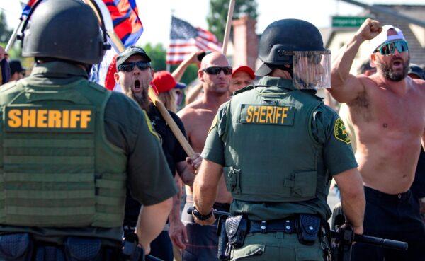 Orange County Sheriff deputies keep protesters and counter-protesters apart in Yorba Linda, Calif., on Sept. 26, 2020. (Mindy Schauer/The Orange County Register via AP)
