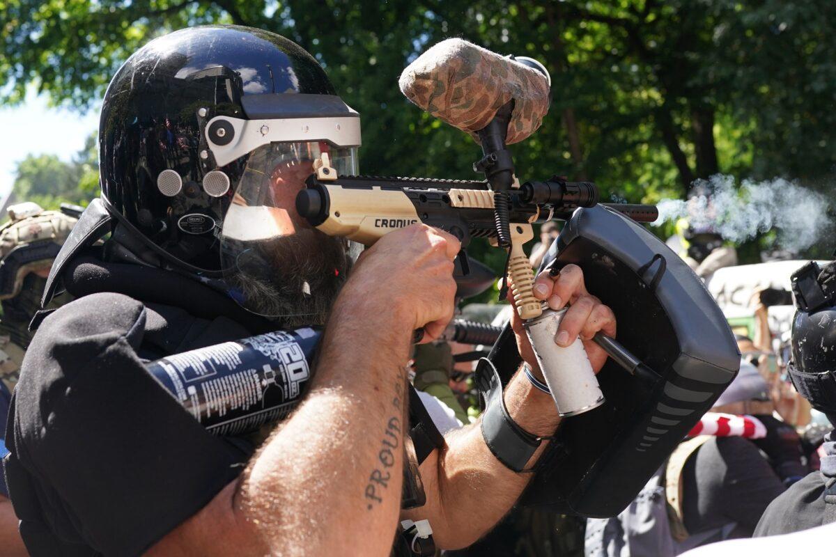  Alan Swinney fires a paintball gun in Portland, Ore., Aug. 22, 2020. (Nathan Howard/Getty Images)