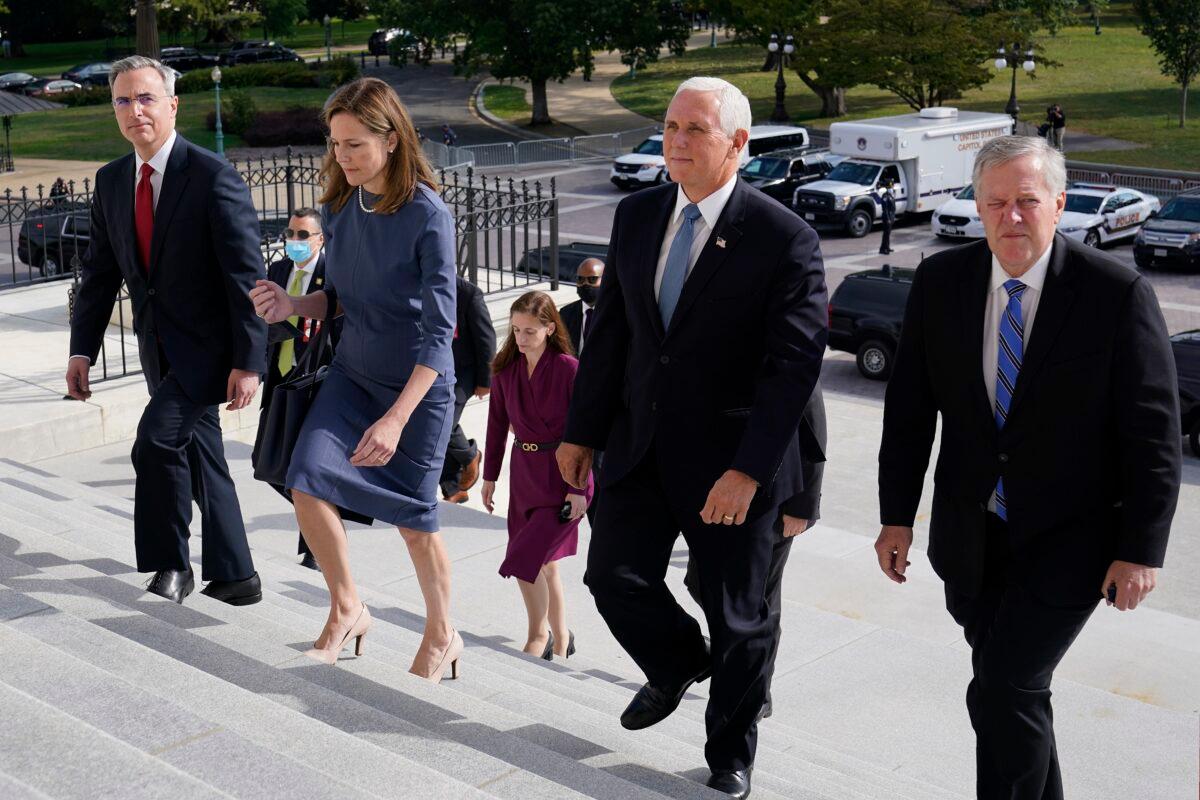 Seventh U.S. Circuit Court Judge Amy Coney Barrett, second from left, President Donald Trump's nominee for the U.S. Supreme Court, is escorted to the Senate by Vice President Mike Pence, second from right, White House chief of staff Mark Meadows, right, and White House counsel Pat Cipollone, left, as she begins a series of meetings to prepare for her confirmation hearing, at the U.S. Capitol in Washington on Sept. 29, 2020. (Susan Walsh/Pool/Getty Images)