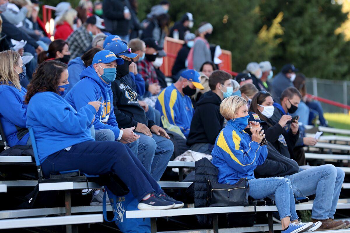  Fans sit in the stands wearing masks during a high school football game in Clinton, Mich., on Sept. 18, 2020. (Justin Casterline/Getty Images)