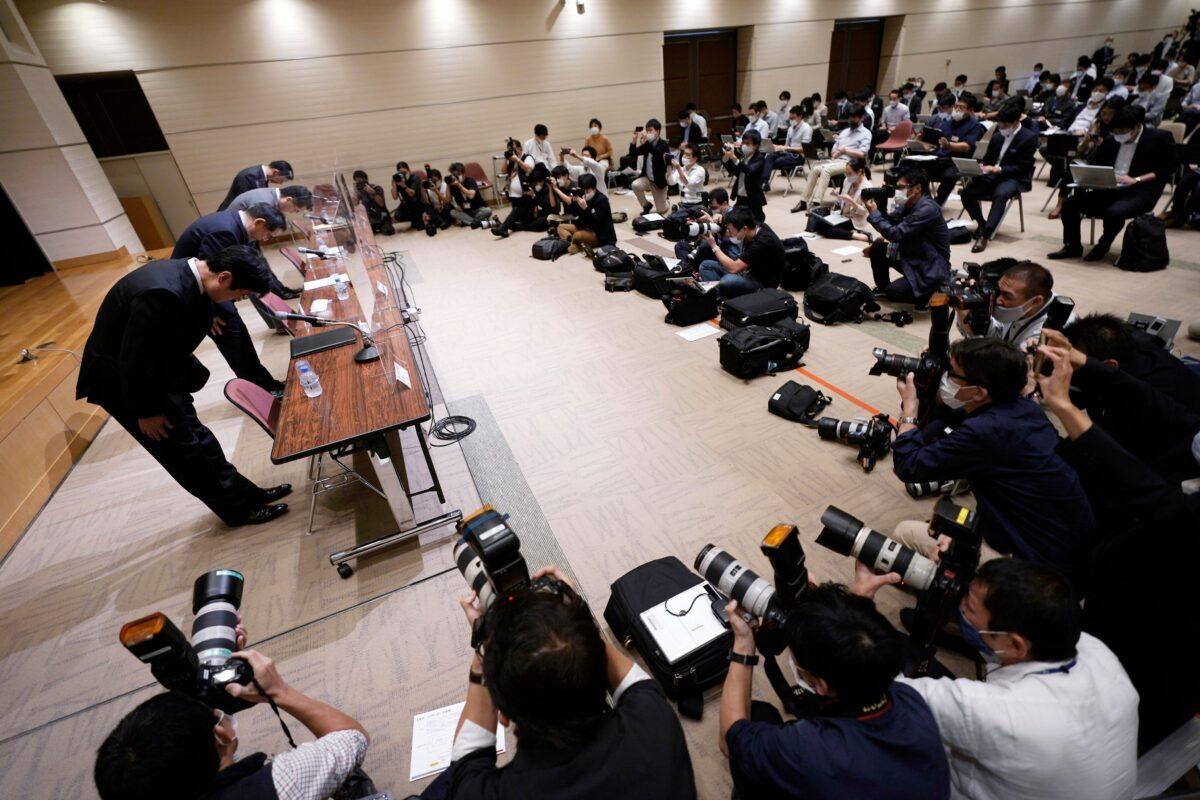 Koichiro Miyahara, second from left, President and CEO of Tokyo Stock Exchange, Inc. (TSE), and other officers bow during a press conference at the Tokyo Stock Exchange in Tokyo, Japan, on Oct. 1, 2020. (Eugene Hoshiko/AP Photo)