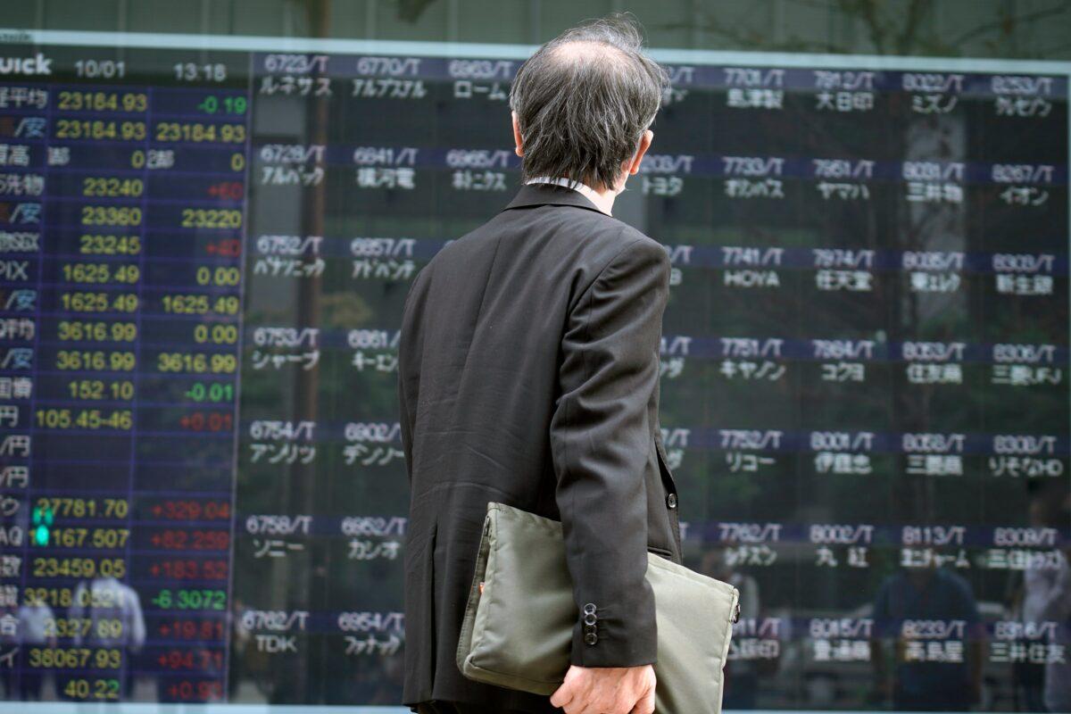 A man looks at an electronic stock board supposedly showing Japan's Nikkei 225 index at a securities firm, in Tokyo, Japan, on Oct. 1, 2020. (Eugene Hoshiko/AP Photo)
