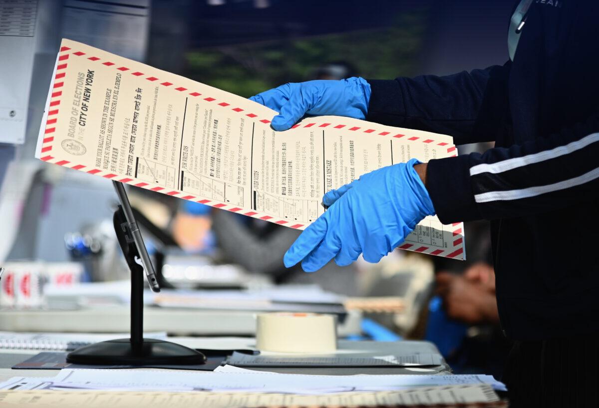 Board of Election employees and volunteers help voters in New York City during the New York Democratic presidential primary elections on June 23, 2020. (Angela Weiss/AFP via Getty Images)