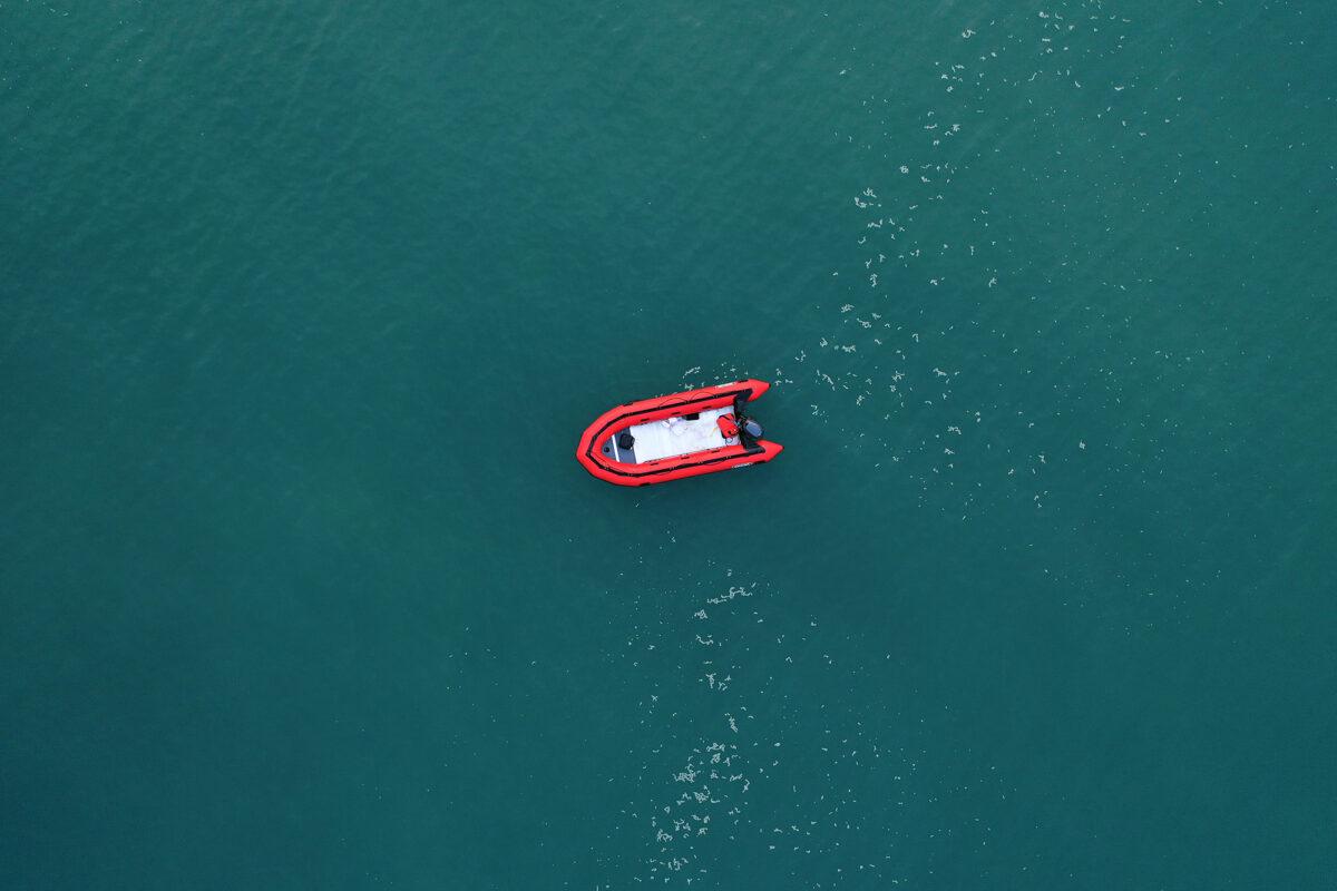 In this aerial image from a drone, an empty migrant dinghy floats off the beach at St Margaret's Bay after the occupants landed in Dover, England, from France on September 11, 2020. (Christopher Furlong/Getty Images)
