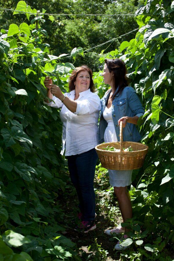 The author (R) and her mother harvest the garden together. (Courtesy of Julie Ann Sageer)