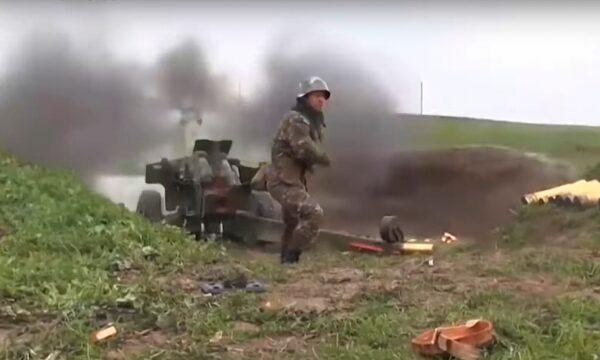 An Armenian serviceman fires a cannon towards Azerbaijan positions at the contact line of the self-proclaimed Republic of Nagorno-Karabakh, Azerbaijan, on Oct. 2, 2020. (Armenian Defense Ministry/AP)