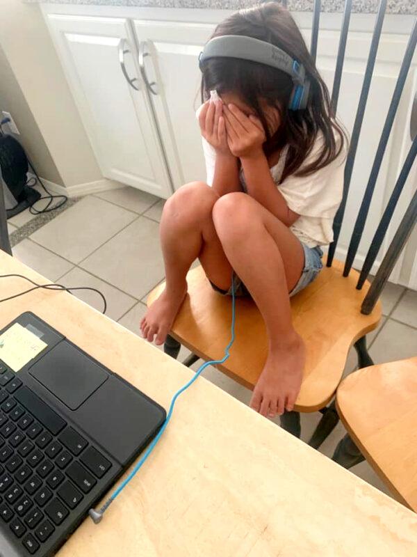 One of Joseph Chang's five daughters cries due to frustrations with the online format of her second-grade class, in Kern County, Calif. (Courtesy of Joseph Chang)