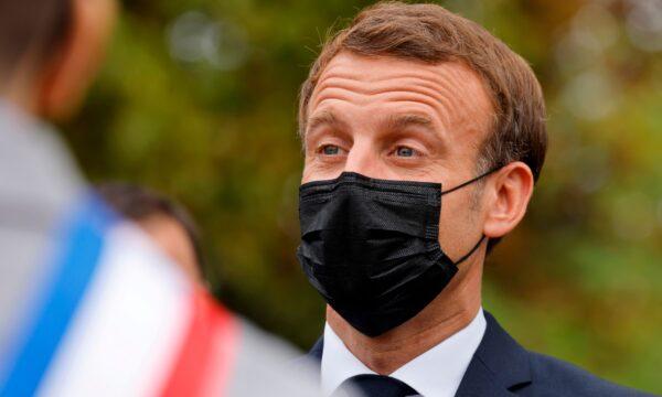 French President Emmanuel Macron wears a protective face mask as he arrives at the 'la Maison des habitants' (MDH) in Les Mureaux, northwest of Paris, on Oct. 2, 2020. (Ludovic Marin/Pool via AP)