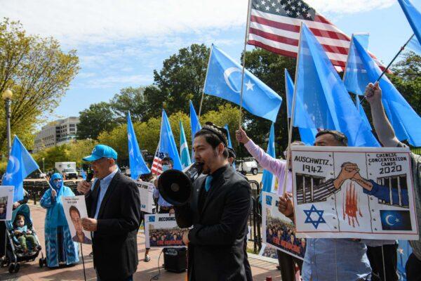 Uyghurs of the East Turkistan National Awakening Movement (ETNAM) hold a rally to protest the 71st anniversary of the People's Republic of China in front of the White House in Washington, DC, on Oct. 1, 2020. (NICHOLAS KAMM/AFP via Getty Images)