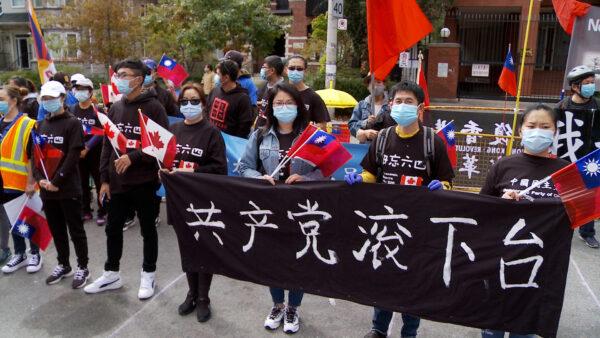 Protesters hold banners saying “Take Down CCP" at the Global Day of Action rally in Toronto on Oct. 1, 2020. (NTD Television)