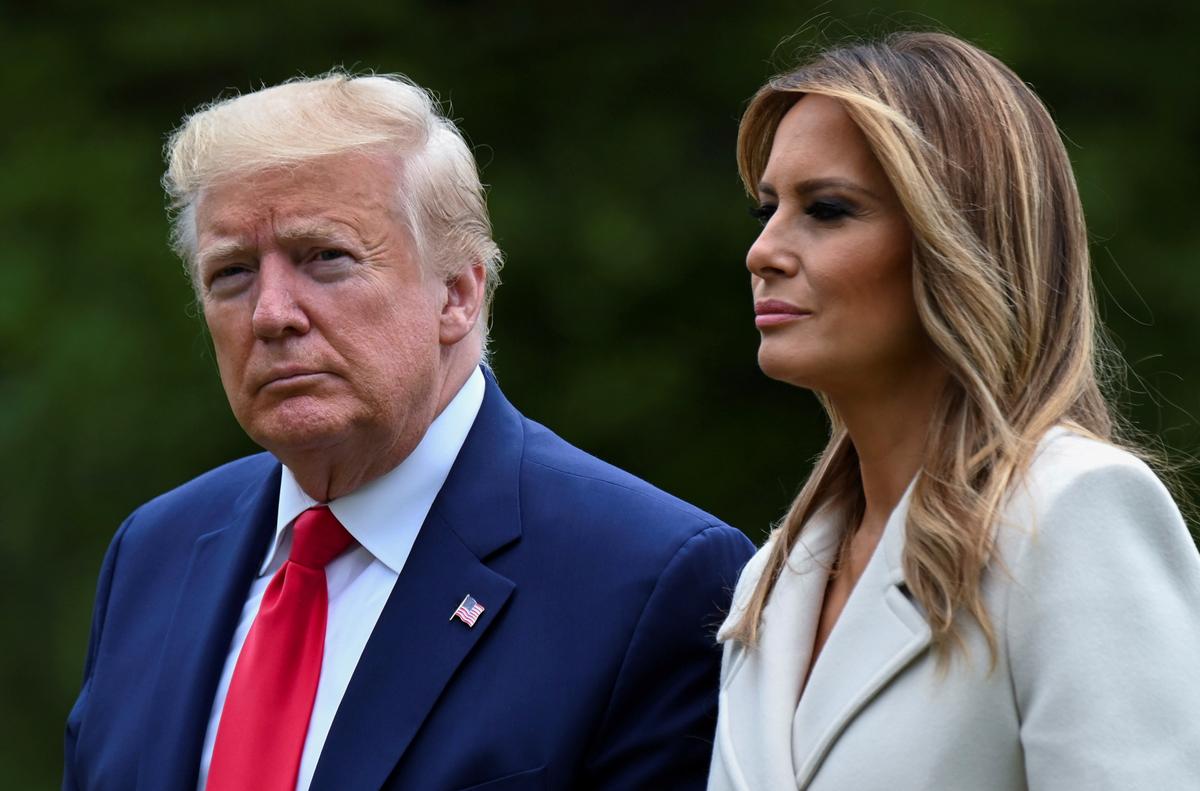 President Donald Trump and First Lady Melania Trump walk from the Marine One helicopter back to the White House after traveling to Fort McHenry in Baltimore, Md., for Memorial Day holiday commemorations from Washington, in a May 25, 2020, file photograph. (Erin Scott/Reuters)