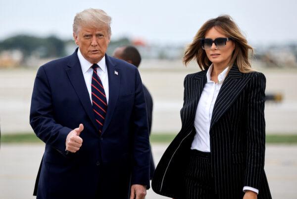 President Donald Trump walks with first lady Melania Trump at Cleveland Hopkins International Airport in Cleveland, Ohio, on Sept. 29, 2020. (Carlos Barria/Reuters)