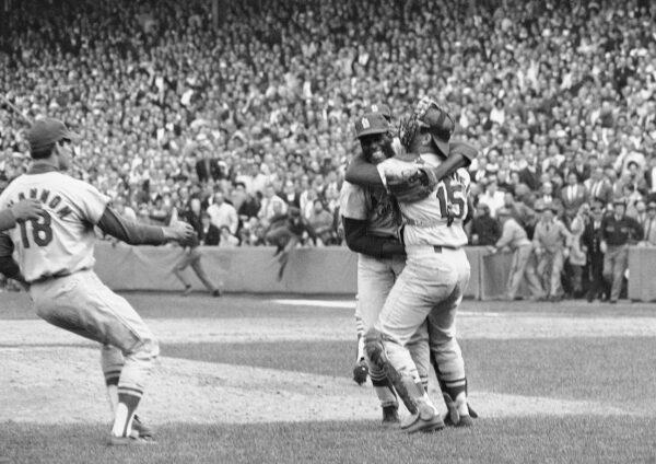 St. Louis Cardinals pitcher Bob Gibson receives a congratulatory hug from catcher Tim McCarver after he pitched a three-hitter in the team's 7-2 victory in Game 7 over the Boston Red Sox to win the World Series at Fenway Park in Boston on Oct. 12, 1967. (AP Photo)