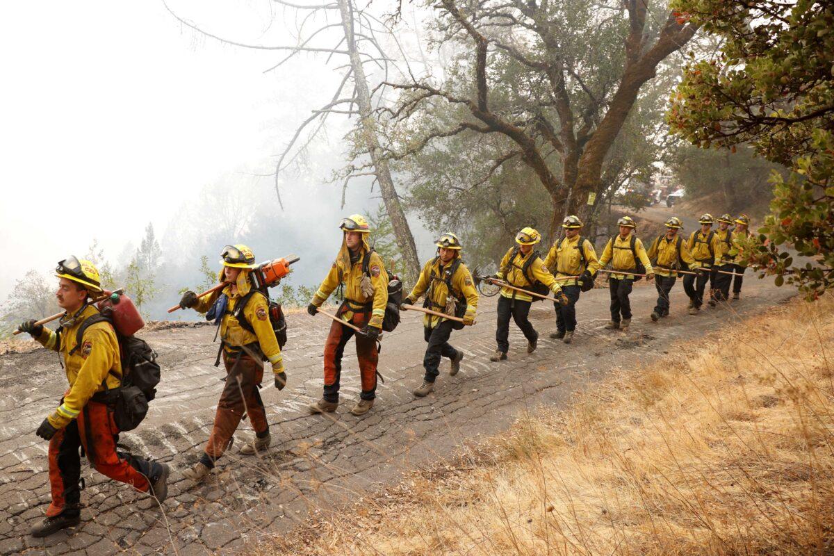 Members of the Cal Fire San Mateo-Santa Cruz Unit (CZU) march along Old Lawley Toll Road during the Glass Fire in Calistoga, Calif., on Oct. 2, 2020. (Stephen Lam/Reuters)