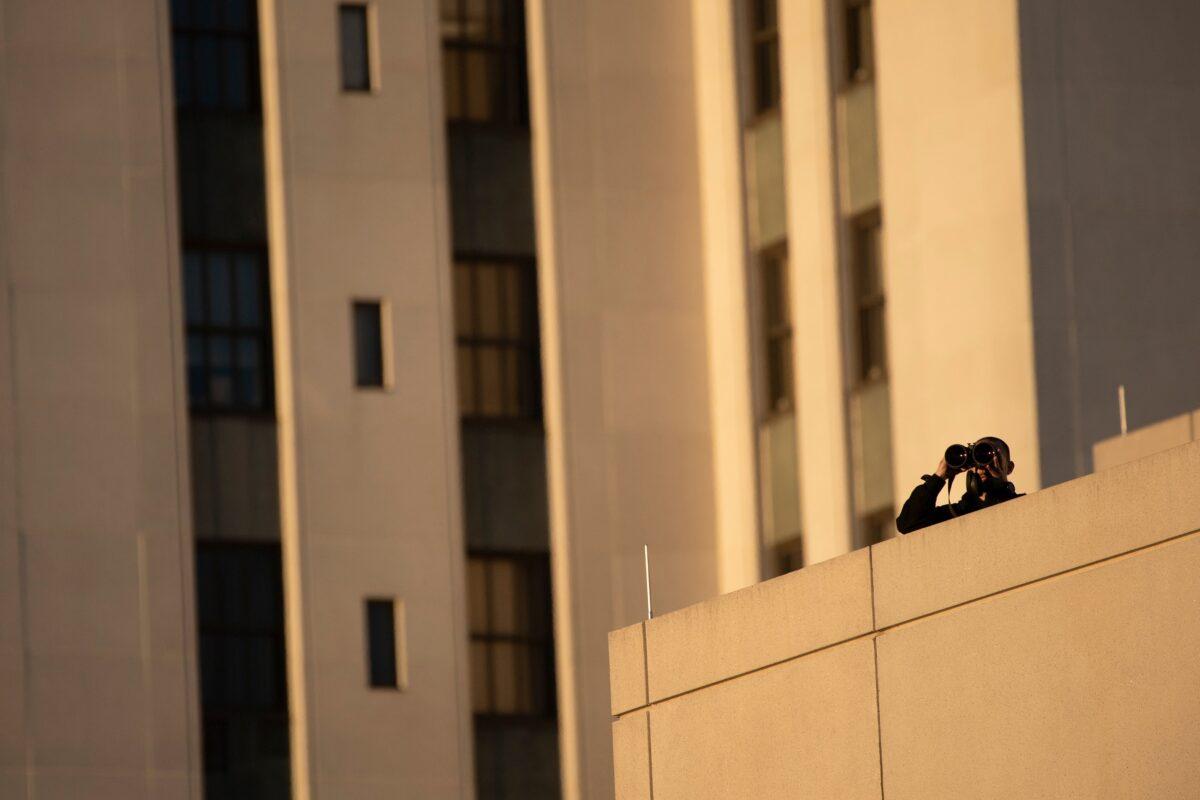 A counter sniper watches while waiting for President Donald Trump to arrive, at Walter Reed National Military Medical Center, in Bethesda, Md., on Oct. 2, 2020. (Brendan Smialowski/AFP via Getty Images)