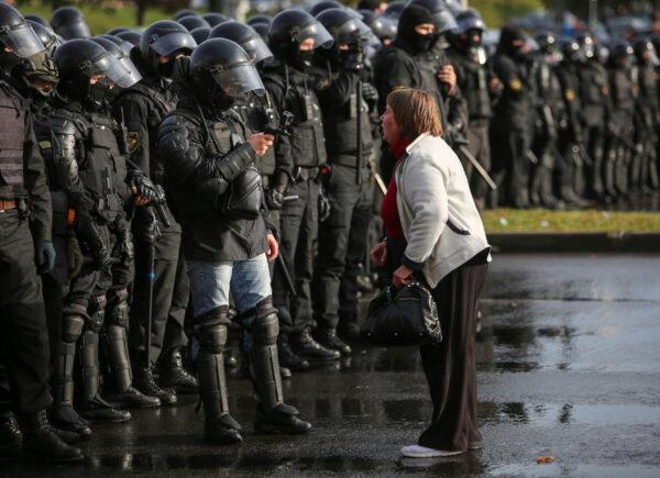 An opposition supporter argues with a police officer during an opposition rally in Minsk on Oct. 4, 2020. (Stringer/Reuters)