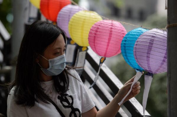 A woman looks at decorative lanterns with messages of goodwill on display for the Mid-Autumn Festival in the Fortress Hill area in Hong Kong on Oct. 4, 2020. (Jayne Russell/AFP via Getty Images)
