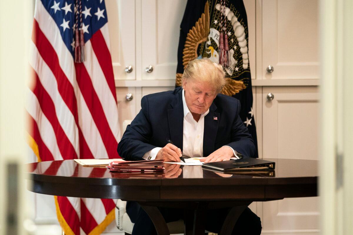 President Donald Trump works in the Presidential Suite at Walter Reed National Military Medical Center in Bethesda, Md., Oct. 3, 2020. (Joyce N. Boghosian/The White House via AP)