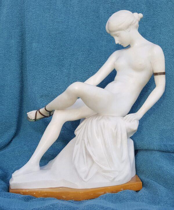 “Seated Maiden Lacing Her Sandal,” 1920, by Ernst Seger. Alabaster and bronze; 16.5 inches tall. (Courtesy of Wayne A. Barnes)