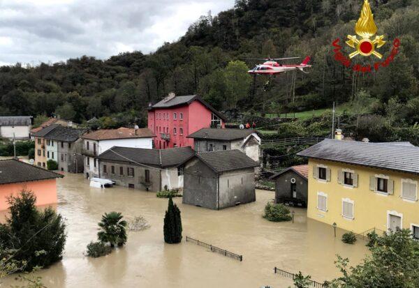 In this image made available on Oct. 4, 2020, a firefighters' helicopter flies over flooding in the town of Ornavasso, in the northern Italian region of Piedmont. (Firefighter Vigili del Fuoco via AP)