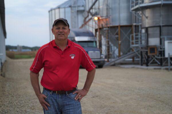 James Leverich stands in front of grain bins he built with his own hands on his farm in Sparta, Wis., on Sept. 17, 2020. (Cara Ding/The Epoch Times)