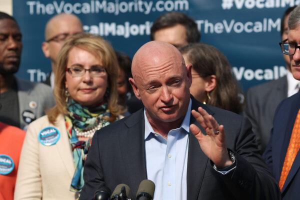 Former astronaut Mark Kelly speaks during a press conference in New York City with his wife, former Rep. Gabby Giffords (D-Ariz.), behind him, on Oct. 17, 2016. (Spencer Platt/Getty Images)