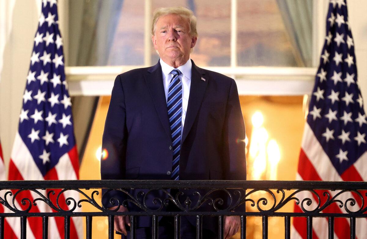 President Donald Trump stands on the Truman Balcony after returning to the White House from Walter Reed National Military Medical Center on Oct. 5, 2020. (Win McNamee/Getty Images)